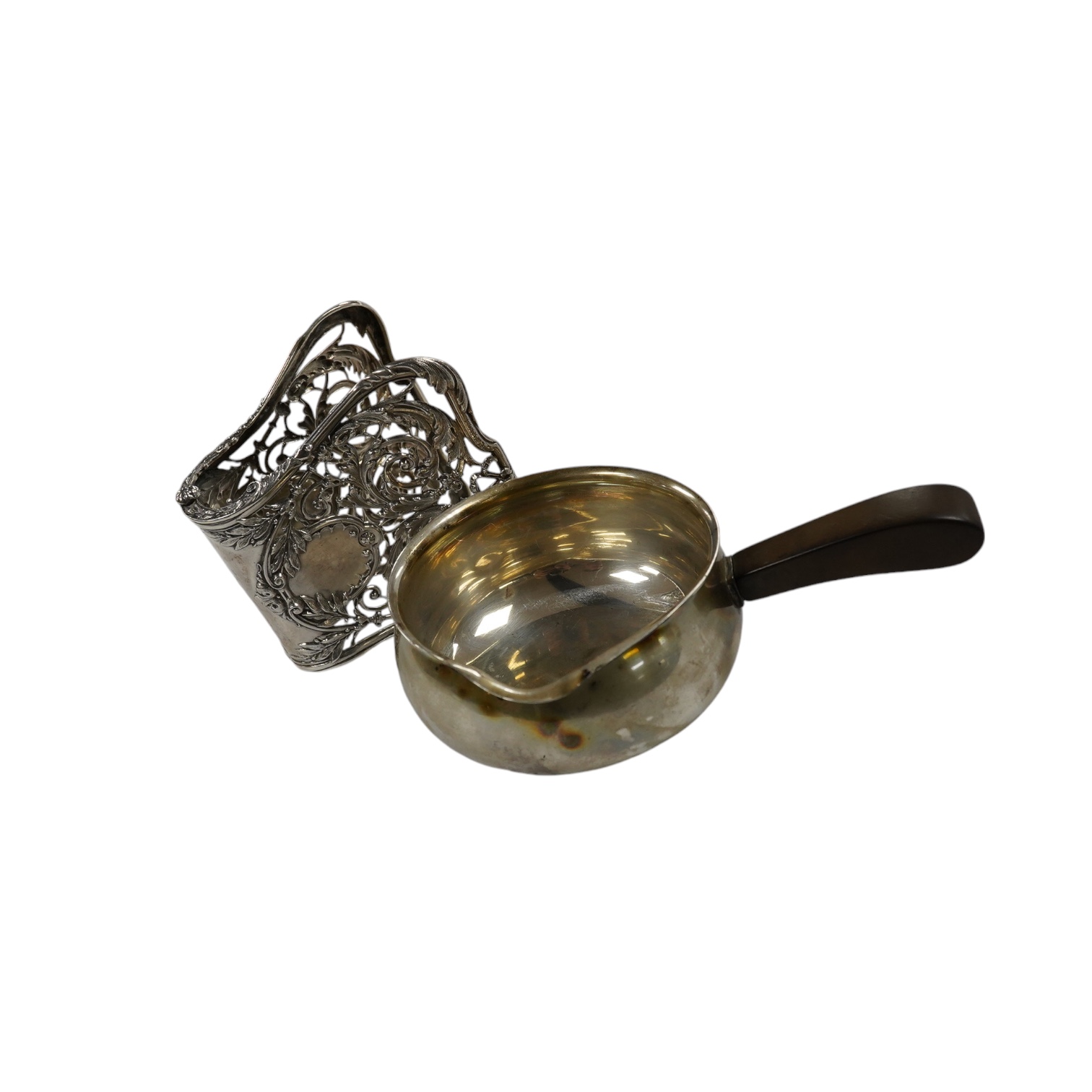 A Danish sterling saucepan, with wood handle, by F. Hingelberg, diameter 95mm and a pair of French pierced plated serving tongs. Condition - poor to fair